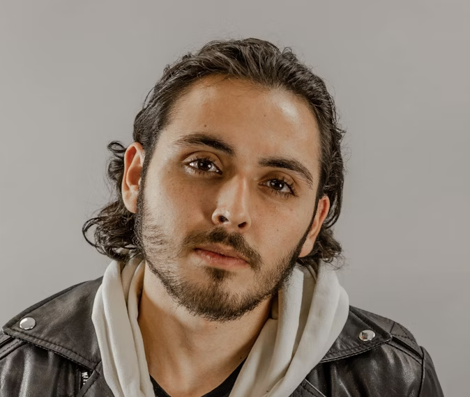 Man with beard and long hair in a leather jacket