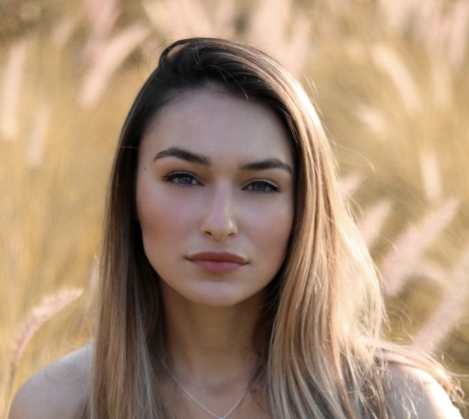 Woman with straight blonde hair standing outside